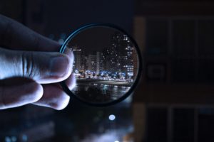 Magnifying glass looking on a city
