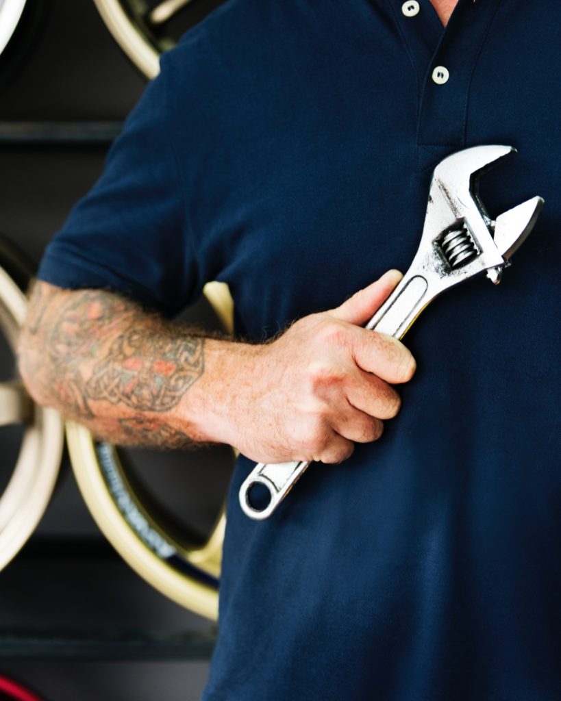 Male mechanic holding a wrench